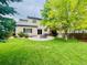 Well-maintained backyard with a circular patio and green lawn, perfect for outdoor relaxation at 21238 Snowshoe Ln, Parker, CO 80138