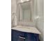 Elegant bathroom with marble countertop and a stylish navy blue vanity at 21238 Snowshoe Ln, Parker, CO 80138