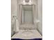 Elegant bathroom with marble countertop and a stylish navy blue vanity at 21238 Snowshoe Ln, Parker, CO 80138