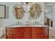 Elegant bathroom featuring a double vanity with granite countertop, and decorative mirrors at 21238 Snowshoe Ln, Parker, CO 80138