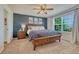 Comfortable bedroom with decorative accent wall, ceiling fan, and natural light at 21238 Snowshoe Ln, Parker, CO 80138