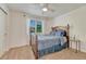 Comfortable bedroom with a large window and a modern ceiling fan, neutral-colored walls at 21238 Snowshoe Ln, Parker, CO 80138
