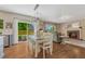 Bright dining room adjacent to kitchen featuring hardwood floors, sliding doors, and an open flow to the living area at 21238 Snowshoe Ln, Parker, CO 80138