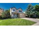 Charming two-story home featuring manicured lawn, a front porch, and attached two-car garage at 21238 Snowshoe Ln, Parker, CO 80138