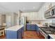 Modern kitchen features stainless steel appliances, ample cabinet space, and island at 21238 Snowshoe Ln, Parker, CO 80138