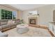 Cozy living room features brick fireplace, large windows, and comfortable seating at 21238 Snowshoe Ln, Parker, CO 80138