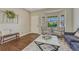 Cozy living room with hardwood floors, neutral walls, a bay window, and comfortable seating at 21238 Snowshoe Ln, Parker, CO 80138
