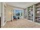 Bright living room featuring a bay window, built-in bookshelves, and a cozy seating area with a blue chair at 21238 Snowshoe Ln, Parker, CO 80138