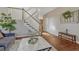 Spacious living room with hardwood floors, staircase, modern decor and a view of the front entryway at 21238 Snowshoe Ln, Parker, CO 80138