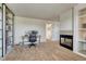Spacious room with fireplace, built-in shelving, and a desk area for work or hobbies at 21238 Snowshoe Ln, Parker, CO 80138