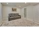 Bright living room features a comfy sofa, neutral carpet, and access to the bathroom at 21238 Snowshoe Ln, Parker, CO 80138