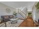 Comfortable living room with hardwood floors, staircase, and views of the dining area at 21238 Snowshoe Ln, Parker, CO 80138