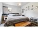 Serene bedroom featuring soft gray bedding, natural light, and personal touches at 3623 S Sheridan Blvd # 12, Denver, CO 80235