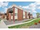 Brick apartment building with private balconies, grassy common areas, and walkways at 3623 S Sheridan Blvd # 12, Denver, CO 80235