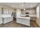 Modern kitchen with island, gray cabinets, and white countertops at 18134 Prince Hill Cir, Parker, CO 80134