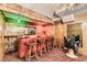 Basement bar featuring a unique design with vintage bar stools, creating a retro entertainment space at 7251 Larsh Dr, Denver, CO 80221