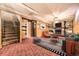 Finished basement with stone fireplace, carpet flooring, and wood paneled walls creating a cozy atmosphere at 7251 Larsh Dr, Denver, CO 80221