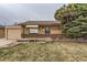 Charming single-story brick home with well-maintained front yard and mature landscaping at 7251 Larsh Dr, Denver, CO 80221