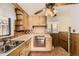 Cozy kitchen featuring wood cabinets, and retro finishes, blending functionality with classic charm at 7251 Larsh Dr, Denver, CO 80221