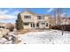 Backyard of a two-story home with a patio and snow-covered lawn at 9847 Helena Ct, Commerce City, CO 80022