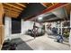 Basement with exposed ceiling and workout equipment at 9847 Helena Ct, Commerce City, CO 80022