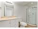 A modern bathroom featuring a glass-enclosed shower and a vanity with plenty of storage space at 9847 Helena Ct, Commerce City, CO 80022