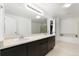 Bathroom featuring dual sinks, a large mirror, and a separate shower and bathtub at 9847 Helena Ct, Commerce City, CO 80022