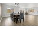 Elegant dining room with wood floors, a modern dining table, and lots of natural light at 9847 Helena Ct, Commerce City, CO 80022