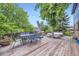 An outdoor deck with a dining table, seating, and string lights, ideal for entertaining or enjoying a meal outdoors at 10621 Julian St, Westminster, CO 80031