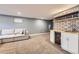 Finished basement with wet bar, a sofa, shelves, mini-fridge, and carpet at 10621 Julian St, Westminster, CO 80031