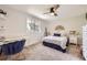 Bedroom featuring a ceiling fan, a desk, and a window with a tree view at 10621 Julian St, Westminster, CO 80031