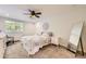Cozy bedroom with a ceiling fan, a bright window and an stylish full-length mirror at 10621 Julian St, Westminster, CO 80031