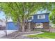 Charming home with a brick facade, a two-car garage, and a well-manicured lawn, showcasing curb appeal at 10621 Julian St, Westminster, CO 80031