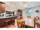 Spacious kitchen with stainless steel appliances, wood cabinets, and a dining area with a chandelier at 10621 Julian St, Westminster, CO 80031