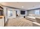 Spacious living room with a large sectional sofa and mounted flat-screen TV, perfect for relaxation and entertainment at 10621 Julian St, Westminster, CO 80031
