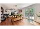 Bright living room with hardwood floors, fireplace, and french doors leading to the backyard at 10621 Julian St, Westminster, CO 80031