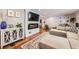 Stylish living room with hardwood floors, modern fireplace, large TV, and open floor plan at 10621 Julian St, Westminster, CO 80031