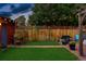 Lush backyard with green lawn, mature trees, and a privacy fence perfect for entertaining guests at 2155 N High St, Denver, CO 80205