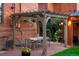 Charming backyard patio with a pergola, a dining area, and a well-manicured lawn at 2155 N High St, Denver, CO 80205