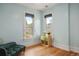 A bright bedroom with natural light, wood floors and pale blue walls create a cozy atmosphere at 2155 N High St, Denver, CO 80205