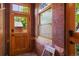 This entryway with brick walls features a wood door and window at 2155 N High St, Denver, CO 80205