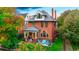 Beautiful brick home with a charming front porch and well-maintained landscaping at 2155 N High St, Denver, CO 80205