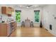 Open kitchen and dining area with hardwood floors and lots of natural light at 2155 N High St, Denver, CO 80205