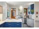 This well-appointed kitchen displays a copper sink, breakfast bar, stainless appliances and wine cooler at 2155 N High St, Denver, CO 80205