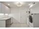 Clean laundry room featuring new washer and dryer and a storage area at 2155 N High St, Denver, CO 80205
