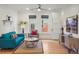Bright living room with hardwood floors, large windows, blue couch and decorative furniture at 2155 N High St, Denver, CO 80205