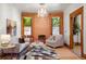 Comfortable living room with exposed brick and a stylish, patterned rug at 2155 N High St, Denver, CO 80205