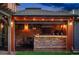 Stylish outdoor kitchen with brick accents, a built-in grill, and ample counter space for cooking at 2155 N High St, Denver, CO 80205