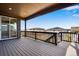 Spacious back deck with black metal railings and view of nearby houses at 14404 Shasta Daisy Pt, Parker, CO 80134