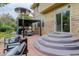 Well-designed backyard patio with steps to the house, comfortable seating, and a modern pergola for outdoor relaxation at 5830 Jasper Pointe Cir, Castle Pines, CO 80108